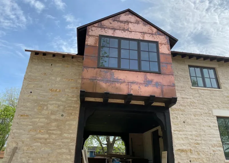Copper metal panel facade on a stone building for Skylight Installation in Crofton